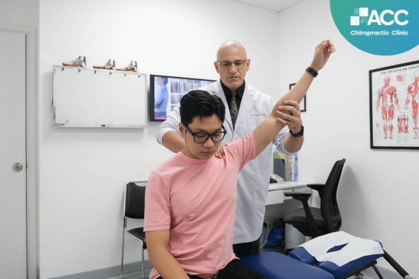 Dr. Marc Tafuro is examining and treating a patient's shoulder joint.