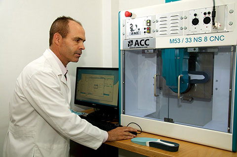 Using a computerized mill to cut the foot orthotic. (Swiss Cad-Cam Process)