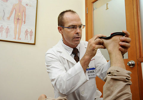 Checking the correction of a carbon fiber foot orthotic.